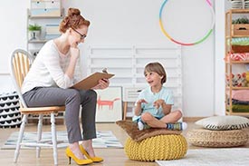 Physiotherepist working with small child