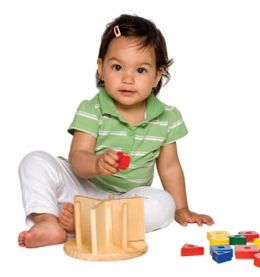 girl sitting on the floor playing with toys