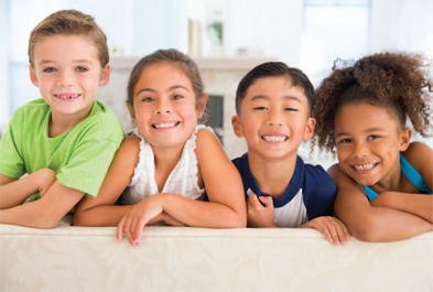 four children smiling at the camera