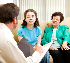 two woman looking at a man with a clip board